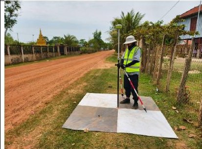 Surveyor recording a ground control point on a checkerboard target