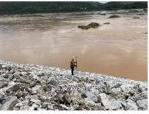 Rocky riverbank surveyed at low water